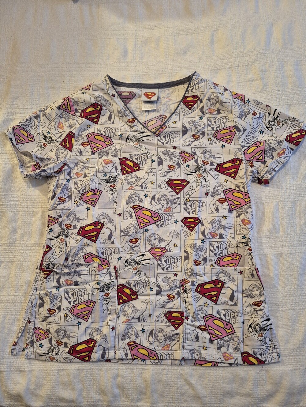 Supergirl women's XS scrub top white with all over logo design VGUC